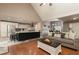Inviting living room featuring hardwood floors, an open floor plan, and a modern kitchen at 128 Champion Way, Hiram, GA 30141