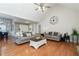 Bright and spacious living room with hardwood floors, comfortable seating, and open access to the dining area at 128 Champion Way, Hiram, GA 30141