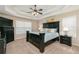 A primary bedroom with a black furniture set, a ceiling fan, and a tray ceiling at 128 Champion Way, Hiram, GA 30141
