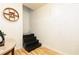 Basement staircase with wooden steps, white walls, and minimalist decor at 128 Champion Way, Hiram, GA 30141