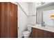 Bathroom featuring vanity, toilet, and full-length folding door to the left at 2540 Park Ave, Austell, GA 30106