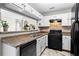 Functional kitchen featuring tile backsplash, black appliances, and a breakfast bar at 2540 Park Ave, Austell, GA 30106