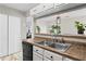 A well-lit kitchen showcases stainless steel appliances and a breakfast bar that opens to living area at 2540 Park Ave, Austell, GA 30106