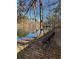 Park bench offers a peaceful view of the lake surrounded by mature trees and natural beauty at 2540 Park Ave, Austell, GA 30106