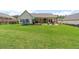 Fenced backyard with green grass, playset, and fire pit - perfect for Gathering activities at 31 Copper Leaf Ct, Villa Rica, GA 30180