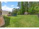 Large, grassy backyard featuring a playground and storage shed, great for outdoor play and storage at 31 Copper Leaf Ct, Villa Rica, GA 30180