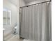 Bathroom featuring a shower with a gray shower curtain and a bright window at 31 Copper Leaf Ct, Villa Rica, GA 30180
