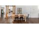 Dining area with farmhouse-style table, black chairs, and sliding barn doors to a storage area at 31 Copper Leaf Ct, Villa Rica, GA 30180
