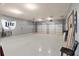 Spacious garage with epoxy flooring, overhead lighting, and ample room for parking and storage at 31 Copper Leaf Ct, Villa Rica, GA 30180
