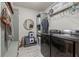 Functional laundry room equipped with modern appliances, storage shelves, and stylish decor elements at 31 Copper Leaf Ct, Villa Rica, GA 30180