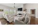 Bright living room with a stone fireplace, ceiling fan, and hardwood floors create a relaxing atmosphere at 31 Copper Leaf Ct, Villa Rica, GA 30180