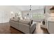 View of a well-lit living room featuring hardwood floors and windows with shutters to the front yard at 31 Copper Leaf Ct, Villa Rica, GA 30180