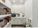Walk-in pantry with ample shelving, white cabinets, and countertop space for appliances at 31 Copper Leaf Ct, Villa Rica, GA 30180