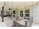 Relaxing outdoor patio with fireplace, swing, and ample seating for comfortable outdoor gatherings at 31 Copper Leaf Ct, Villa Rica, GA 30180