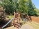 Backyard featuring a playset with a slide, swing and wooded view at 139 Vinca Cir, Suwanee, GA 30024