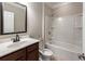 Bathroom featuring vanity with dark wood cabinets and shower-tub combination at 139 Vinca Cir, Suwanee, GA 30024