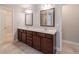 Bathroom with dual vanity, dark cabinets, tile floor and a walk-in shower at 139 Vinca Cir, Suwanee, GA 30024