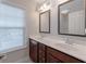 Double vanity bathroom featuring dark wood cabinets and natural lighting at 139 Vinca Cir, Suwanee, GA 30024