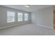 Bright bedroom with multiple windows and neutral carpet at 139 Vinca Cir, Suwanee, GA 30024