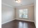 Bedroom featuring modern gray walls, neutral carpet, and a large window at 139 Vinca Cir, Suwanee, GA 30024