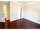 Bedroom with hardwood floors, white trim, and a double door closet at 139 Vinca Cir, Suwanee, GA 30024