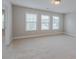 Bright bedroom with large windows and neutral carpet at 139 Vinca Cir, Suwanee, GA 30024