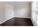 Bedroom featuring modern gray walls, neutral carpet, and a large window at 139 Vinca Cir, Suwanee, GA 30024