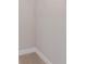Close-up of a simple, functional closet interior with neutral walls and carpeting at 139 Vinca Cir, Suwanee, GA 30024