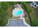 Aerial view of a beautiful community pool with lounge chairs and a covered picnic area at 139 Vinca Cir, Suwanee, GA 30024