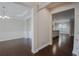 Open-concept dining room leading into kitchen and living room with hardwood floors and decorative trim at 139 Vinca Cir, Suwanee, GA 30024
