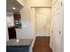 Entryway with hardwood floors, granite countertop bar, a view into kitchen, and access to garage at 139 Vinca Cir, Suwanee, GA 30024