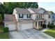 Charming two-story brick home with a three-car garage and manicured front yard at 139 Vinca Cir, Suwanee, GA 30024