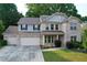 Charming two-story brick home with a three-car garage and manicured front yard at 139 Vinca Cir, Suwanee, GA 30024