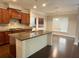 Well-equipped kitchen island with granite countertops, stainless steel sink, and stylish wood cabinetry at 139 Vinca Cir, Suwanee, GA 30024