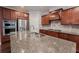 Kitchen with stainless steel appliances, dark wood cabinets, and large island with granite countertops at 139 Vinca Cir, Suwanee, GA 30024