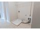 Compact laundry room with tile flooring, dryer hookup, and space for essential appliances at 139 Vinca Cir, Suwanee, GA 30024
