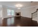 Spacious living room with a cozy fireplace, hardwood floors, and large windows for natural light at 139 Vinca Cir, Suwanee, GA 30024