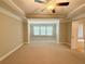 Large bedroom with decorative trey ceiling, ceiling fan, and large windows providing natural light at 139 Vinca Cir, Suwanee, GA 30024