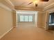 Large bedroom with decorative trey ceiling, ceiling fan, and large windows providing natural light at 139 Vinca Cir, Suwanee, GA 30024