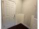 Mud room with hardwood floors, white door to outside, and white brick style backsplash at 139 Vinca Cir, Suwanee, GA 30024