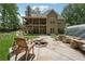 Expansive backyard featuring patio area with fire pit and lush greenery at 2945 Ashbyrn Ct, Buford, GA 30519