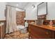 Rustic bathroom featuring stone floors, wood accents, and a unique bucket sink at 2945 Ashbyrn Ct, Buford, GA 30519