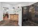 Bathroom featuring a large shower with stone tile and a wooden vanity with dual sinks at 2945 Ashbyrn Ct, Buford, GA 30519
