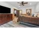 Cozy bedroom with wood-look floors, ceiling fan, and access to closet and bonus room at 2945 Ashbyrn Ct, Buford, GA 30519