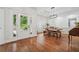 Bright dining room featuring hardwood floors, a farmhouse table, and natural light from the door at 2945 Ashbyrn Ct, Buford, GA 30519