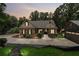 Twilight view of home showcasing stone accents, manicured landscaping, and an inviting driveway at 2945 Ashbyrn Ct, Buford, GA 30519