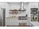 Well-appointed kitchen showcasing stainless steel appliances, gas range, and stylish backsplash at 2945 Ashbyrn Ct, Buford, GA 30519