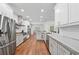 Modern kitchen featuring white cabinetry, stainless steel appliances, and hardwood floors at 2945 Ashbyrn Ct, Buford, GA 30519