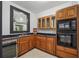 Kitchenette area featuring dark countertops, oak cabinets, and stainless steel appliances at 2945 Ashbyrn Ct, Buford, GA 30519