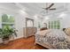 Spacious main bedroom with hardwood floors, tray ceiling, and large windows overlooking the landscape at 2945 Ashbyrn Ct, Buford, GA 30519